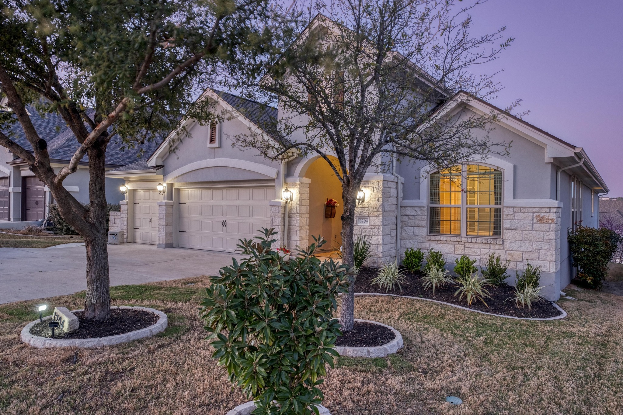 3204 Venezia View Leander, TX 78641 - Photo 28 of 28 Twilight view of front of home featuring trees and landscaping