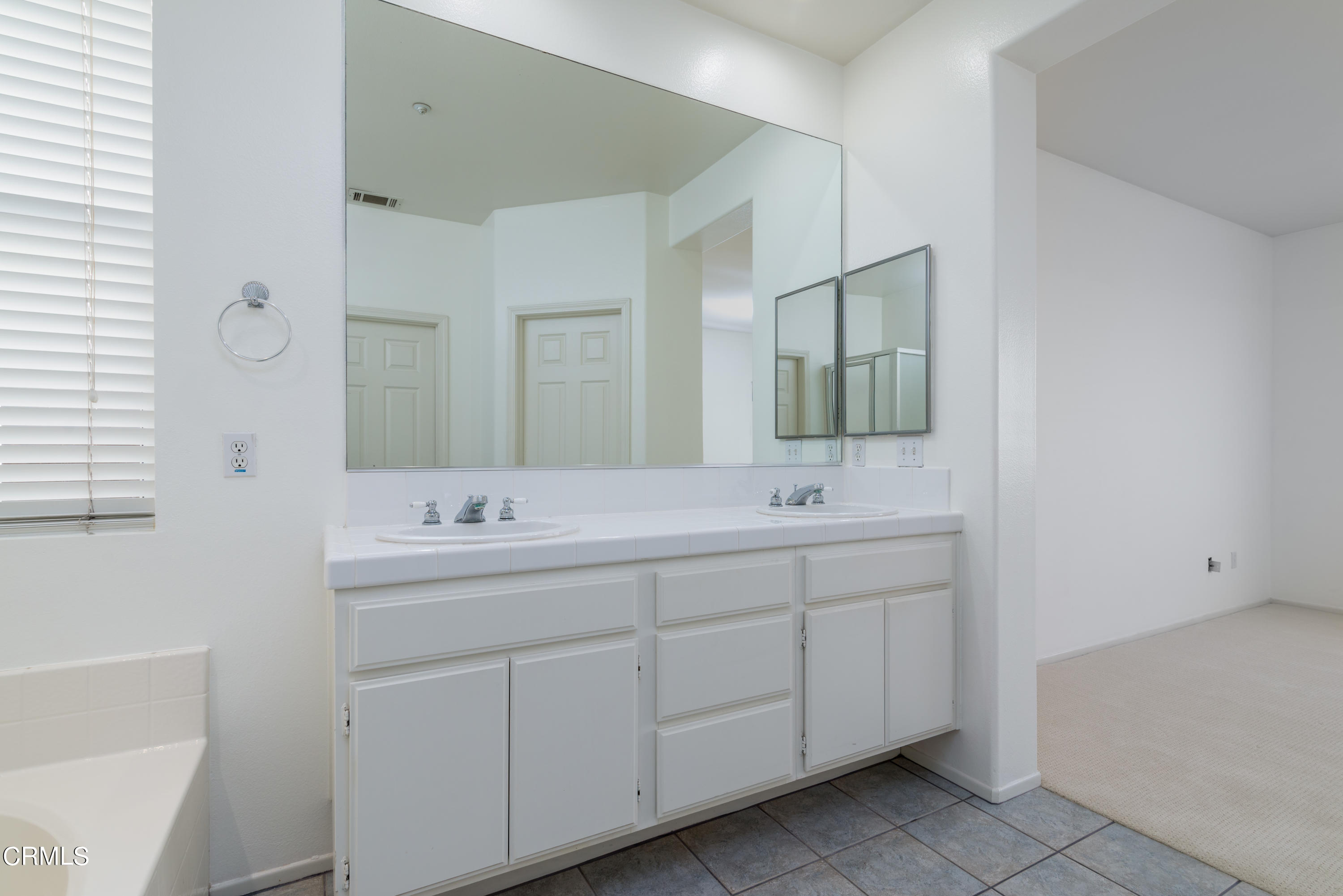 810 Rosalinda Drive Oxnard, CA 93030 - Photo 22 of 24 a bathroom with a double vanity sink and mirror
