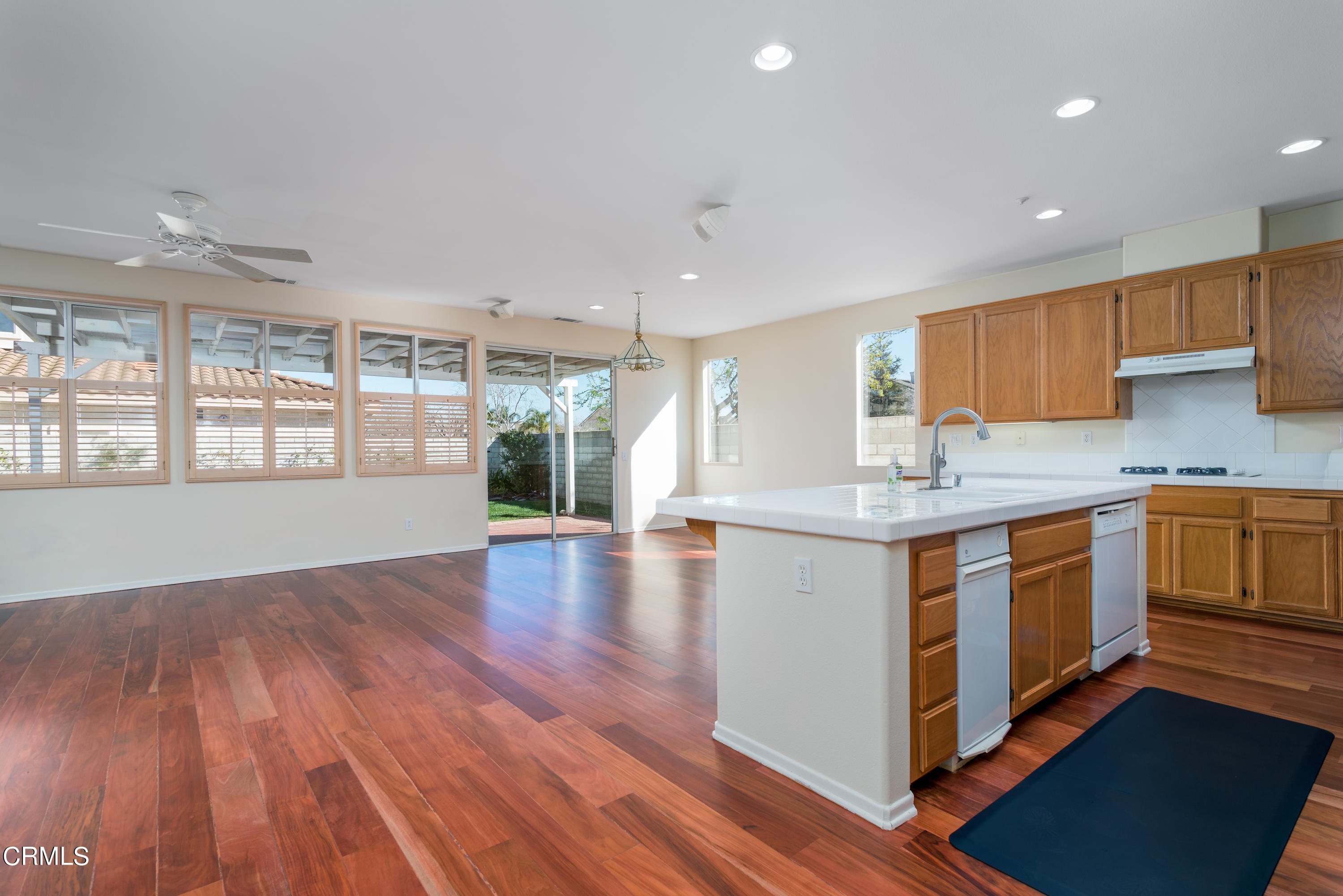 810 Rosalinda Drive Oxnard, CA 93030 - Photo 7 of 24 a kitchen with stainless steel appliances granite countertop wooden floors and white cabinets