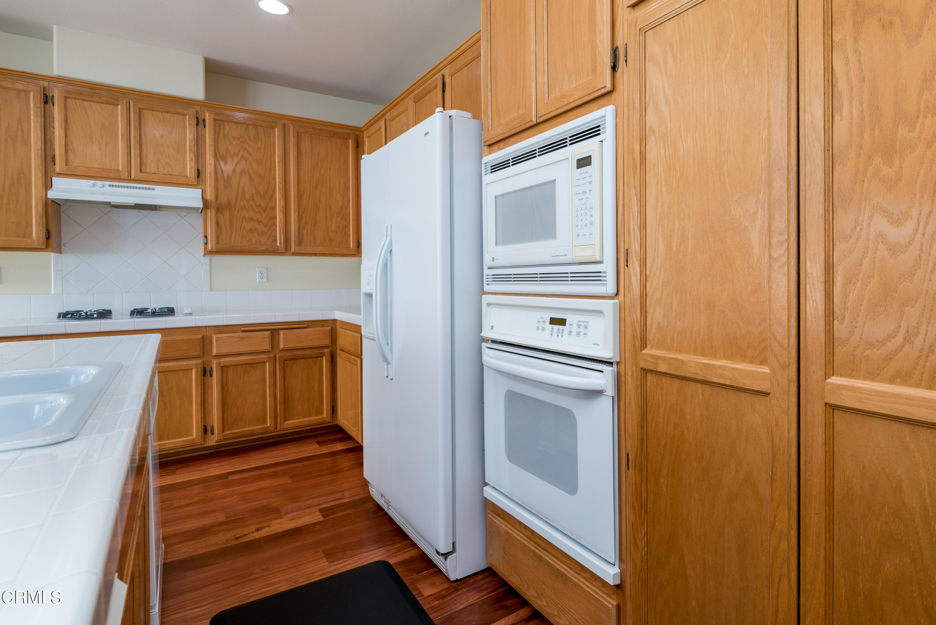 810 Rosalinda Drive Oxnard, CA 93030 - Photo 8 of 24 a kitchen with a refrigerator and cabinets
