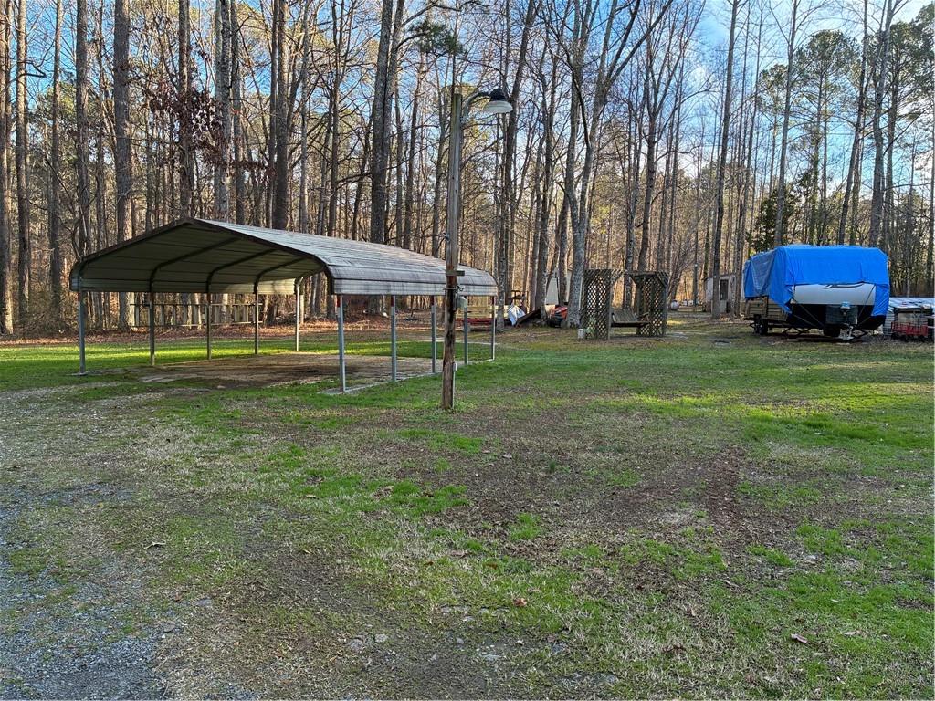 244 Manors Mill Road Dallas, GA 30157 - Photo 24 of 39 a yellow and red umbrella sitting in front of a house