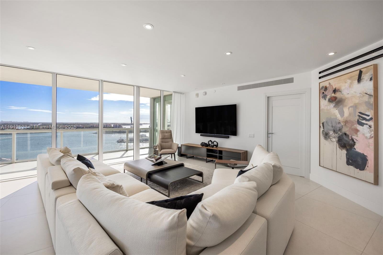 450 Alton Road, Unit 2007 Miami Beach, FL 33139 - Photo 12 of 30 a living room with furniture and a flat screen tv