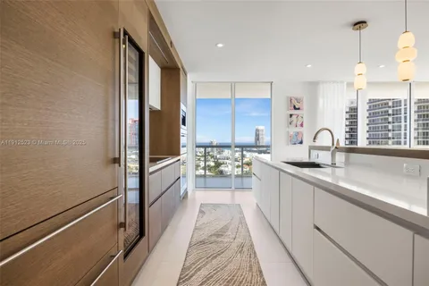 a kitchen with sink refrigerator and microwave