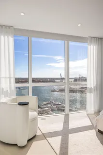 a living room with couch and large windows