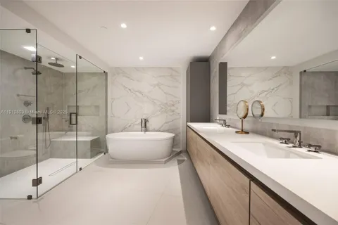 a bathroom with a double vanity sink toilet and shower