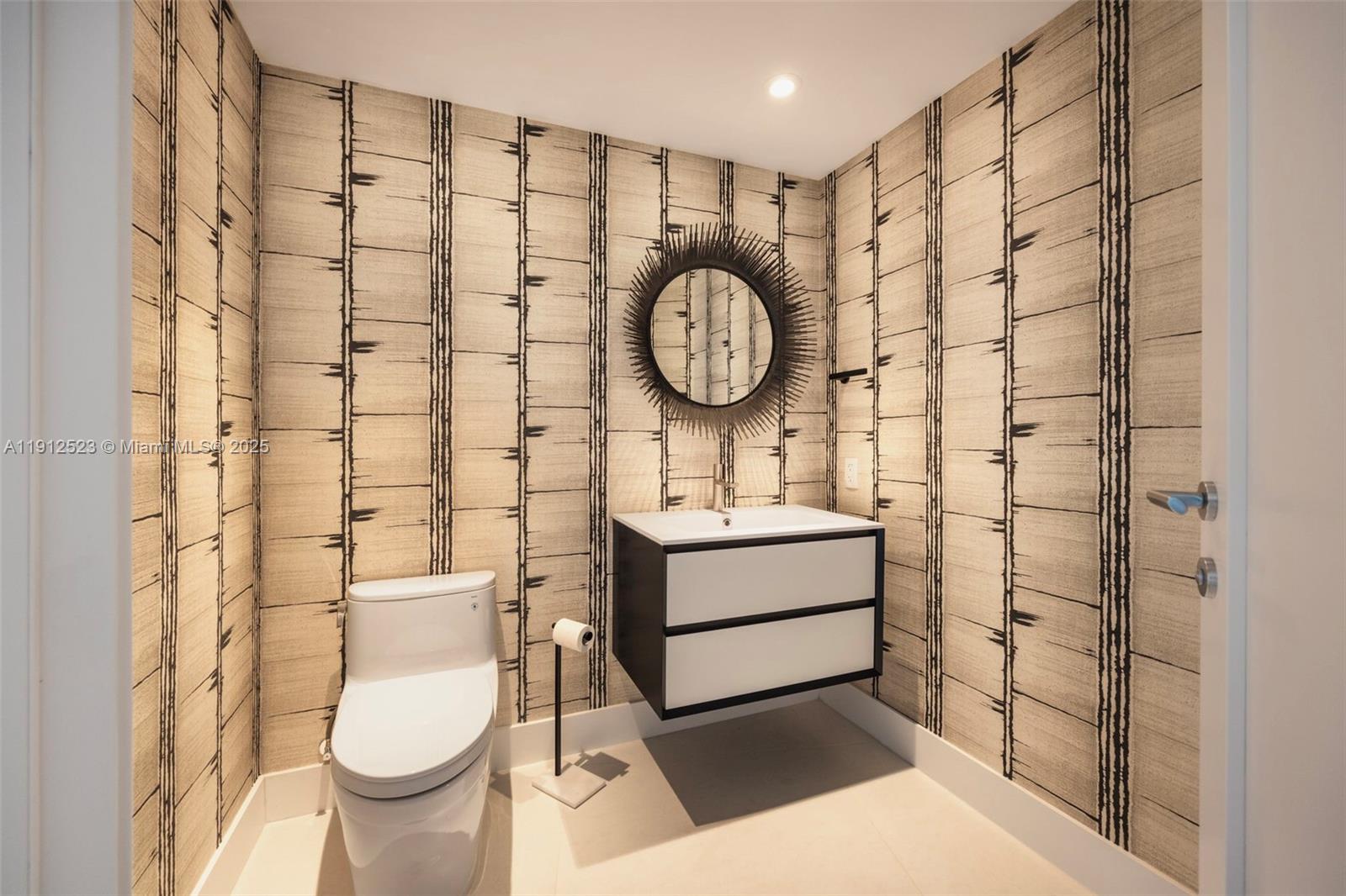 450 Alton Road, Unit 2007 Miami Beach, FL 33139 - Photo 23 of 30 a bathroom with a sink toilet and shower