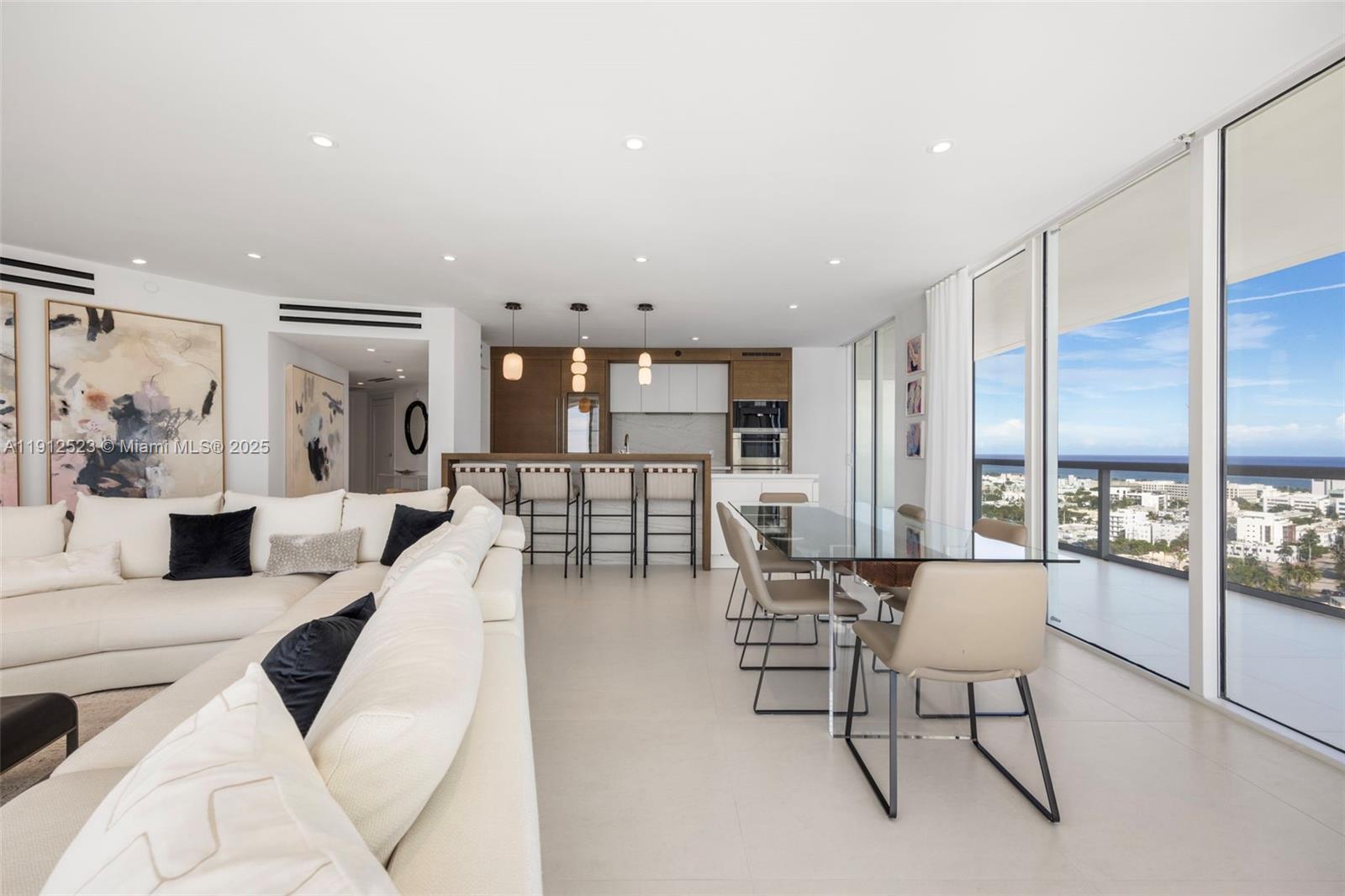 450 Alton Road, Unit 2007 Miami Beach, FL 33139 - Photo 10 of 30 a living room with furniture and a large window