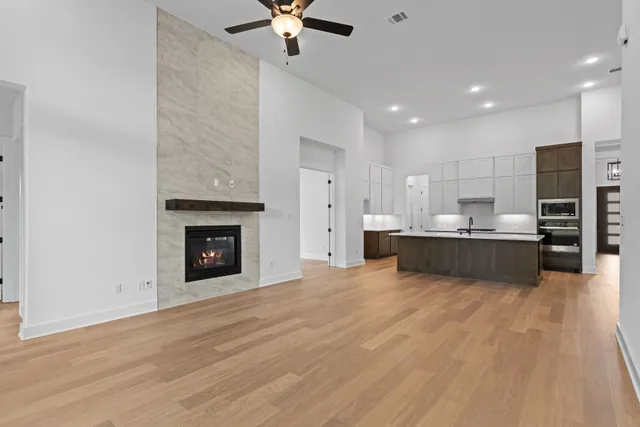 a kitchen with stainless steel appliances granite countertop a sink a stove and a wooden floors