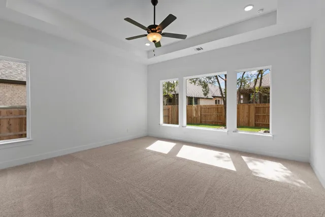 a view of a livingroom with wooden floor and a ceiling fan