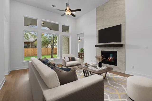 a living room with furniture a fireplace and a flat screen tv