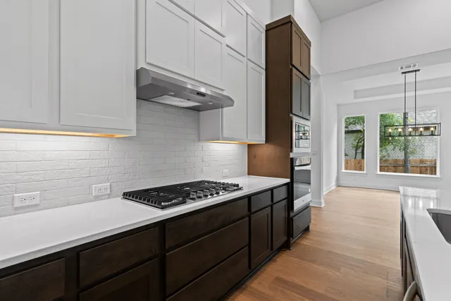 a kitchen with stainless steel appliances a stove and a refrigerator