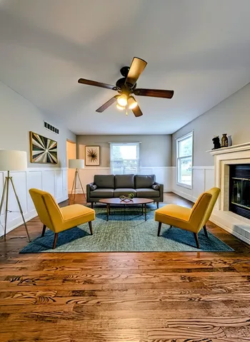 a living room with furniture a rug and a fireplace