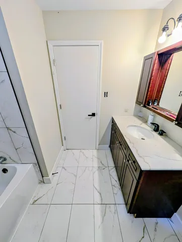 a bathroom with a sink a toilet and mirror