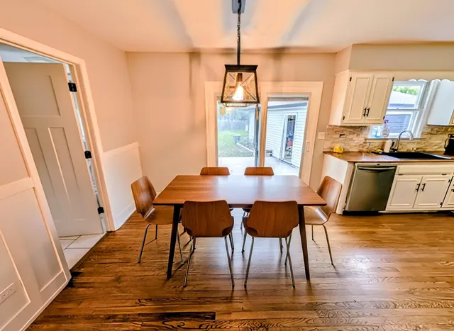 a view of a dining room with furniture window and wooden floor