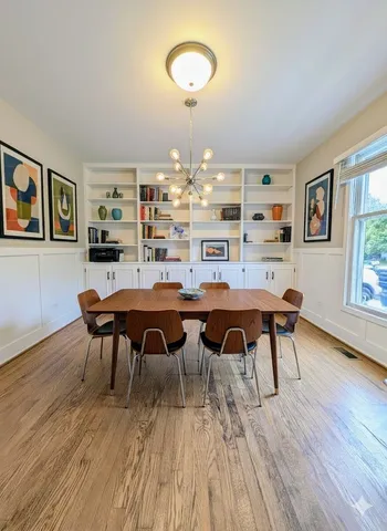 a view of a dining room with furniture and wooden floor