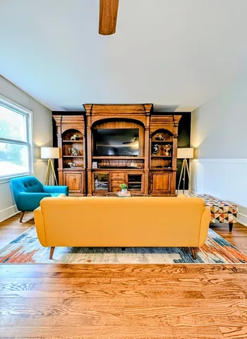 a living room with furniture and a flat screen tv