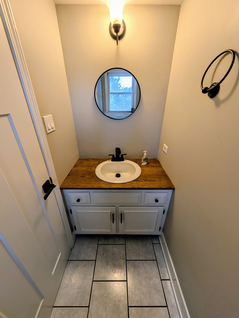 3605 Juniper Avenue Joliet, IL 60431 - Photo 10 of 18 a bathroom with a sink and a mirror