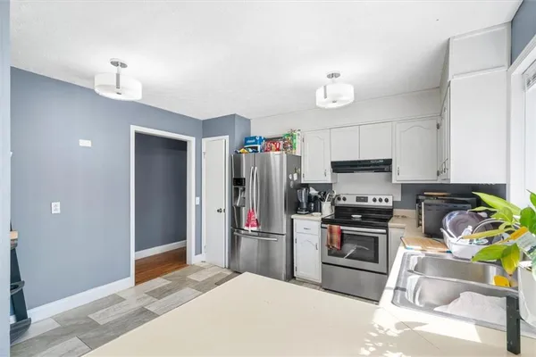 a kitchen with a sink stove and cabinets