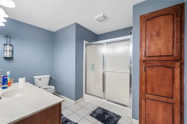 a bedroom with a bed and a chair