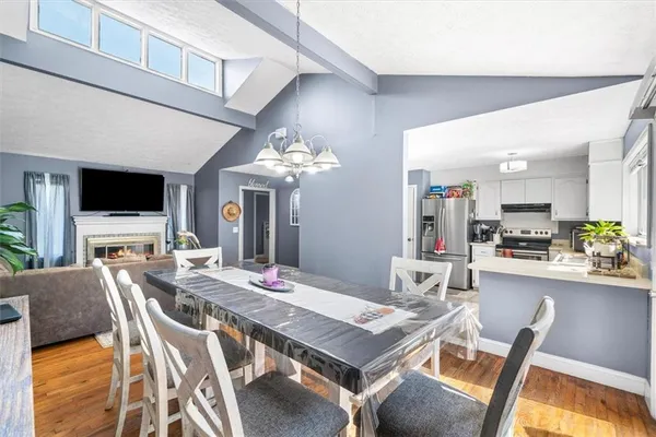 a view of a dining room with furniture and a kitchen