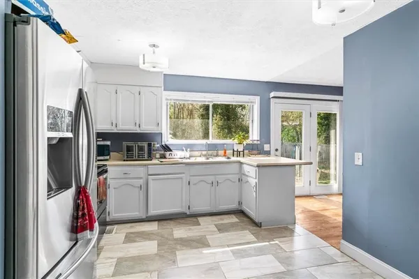 a kitchen with stainless steel appliances a stove refrigerator and microwave