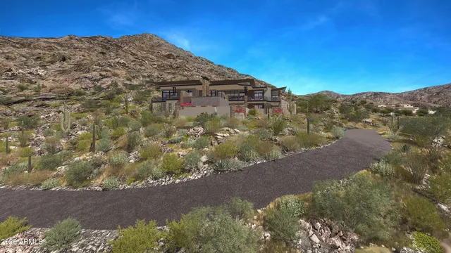 a view of a dry yard with mountains in the background