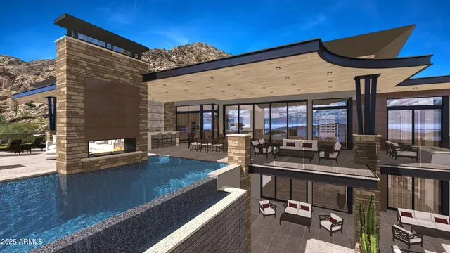 a view of a patio with couches table and chairs under an umbrella