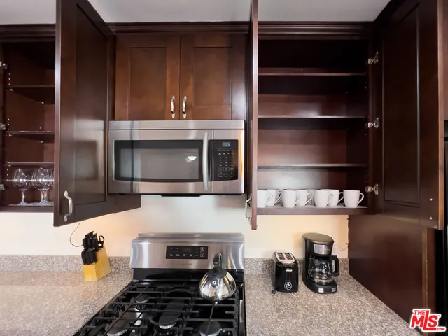 a kitchen with a stove and a refrigerator
