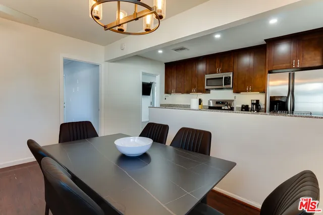 a large kitchen with a table and chairs