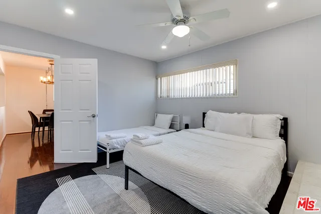 a room with a bed and a chandelier