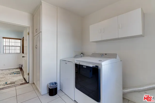 a utility room with sink dryer and washer