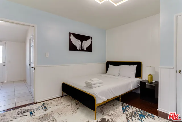 a room with a bed and a dresser