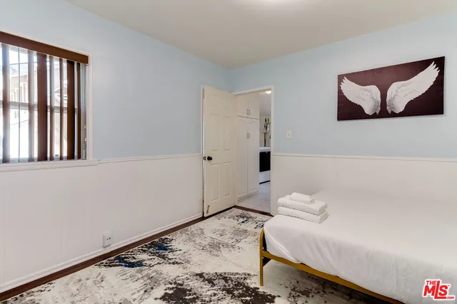 a bedroom with a bed and a couch