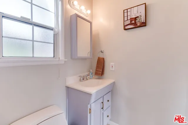 a bathroom with a sink a vanity and a window