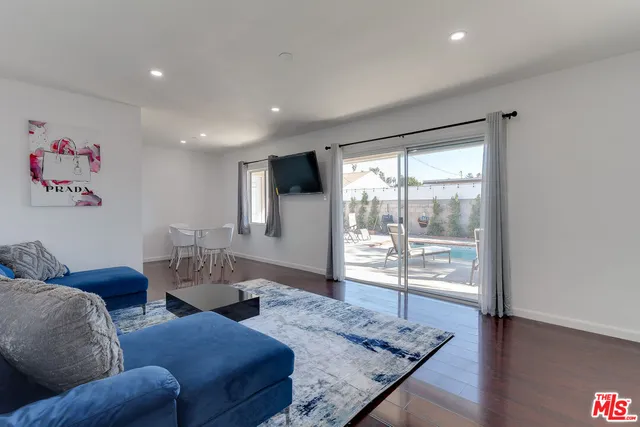 a living room with furniture and a floor to ceiling window