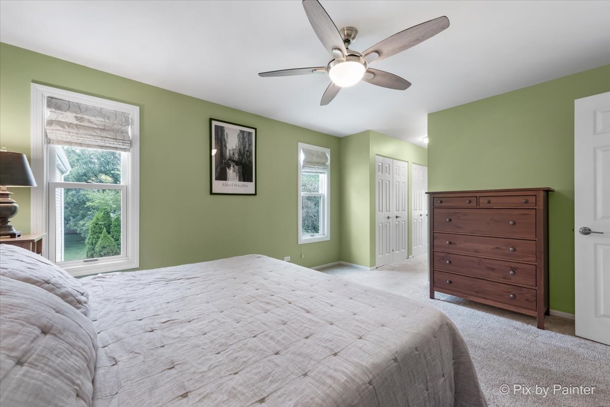 1025 Oswego Road Naperville, IL 60540 - Photo 19 of 42 a bedroom with a large bed and a window
