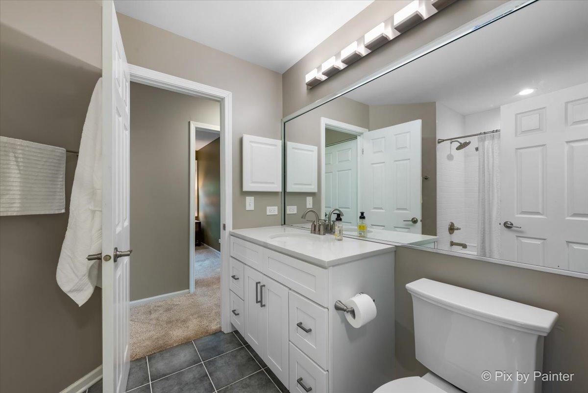 1025 Oswego Road Naperville, IL 60540 - Photo 20 of 42 a bathroom with a double vanity sink mirror and toilet