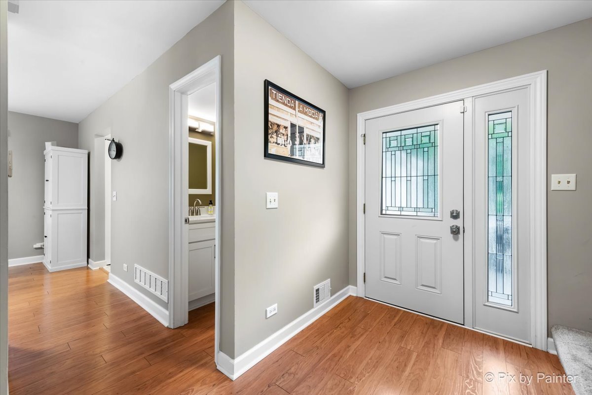 1025 Oswego Road Naperville, IL 60540 - Photo 2 of 42 wooden floor in an empty room with a window