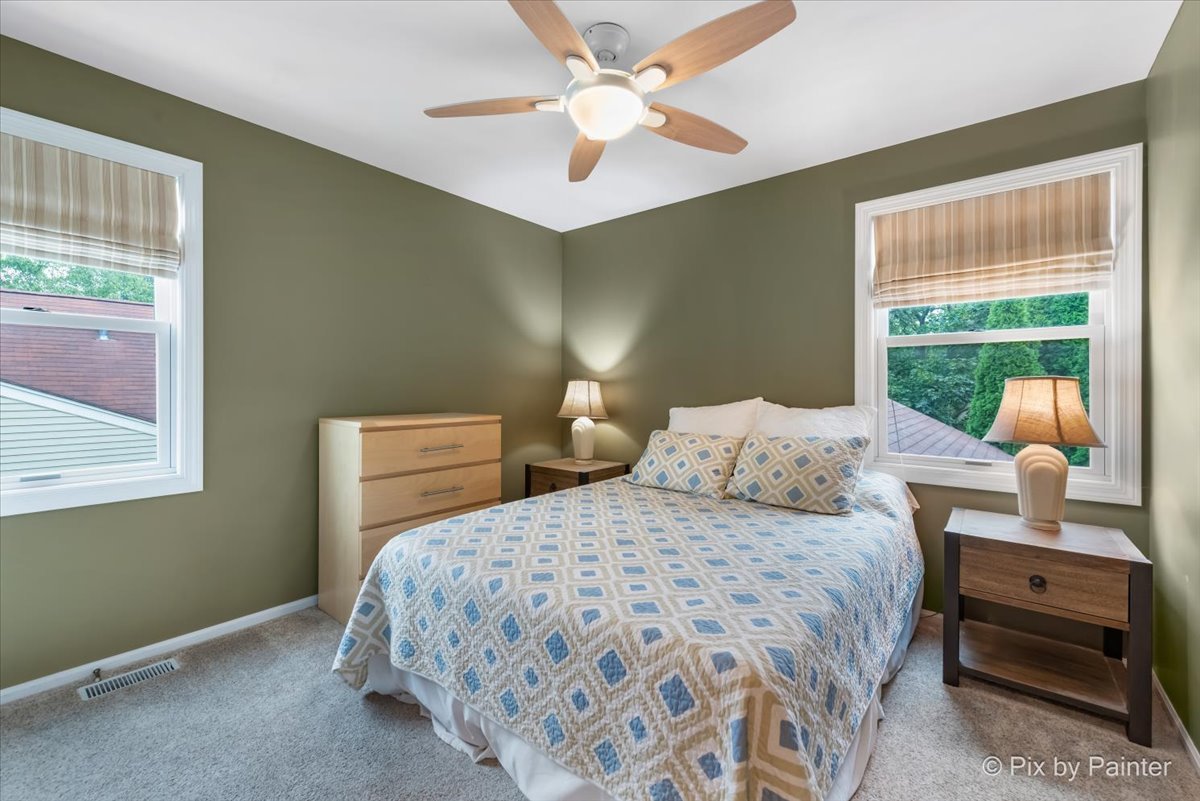 1025 Oswego Road Naperville, IL 60540 - Photo 21 of 42 a bedroom with a bed and a window