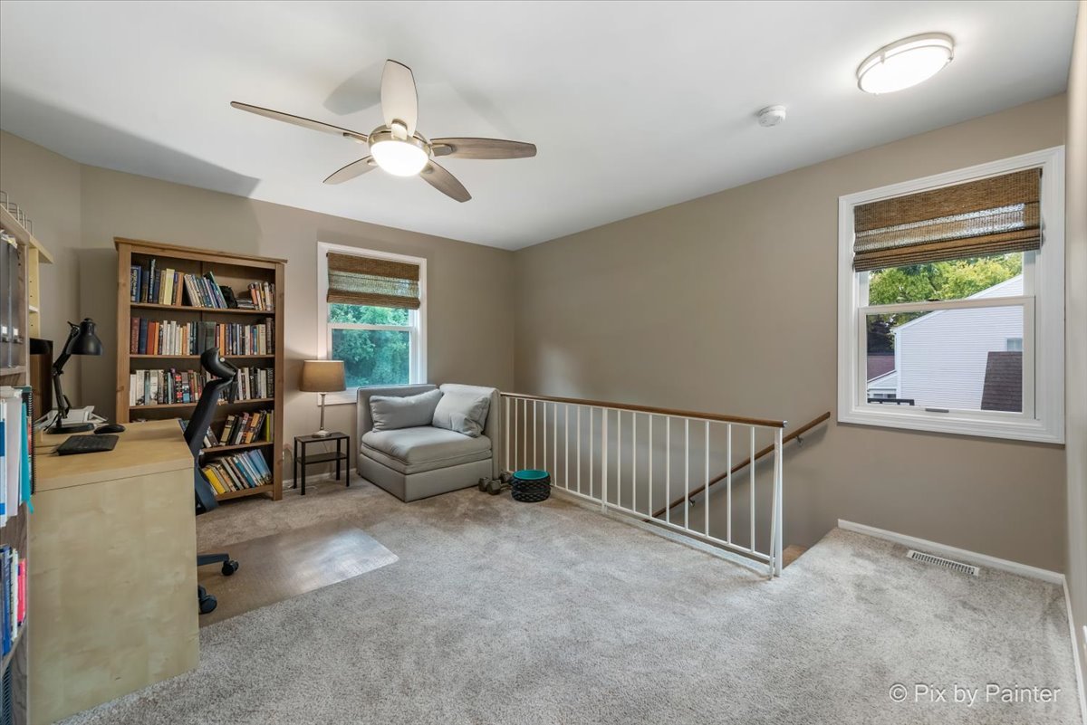 1025 Oswego Road Naperville, IL 60540 - Photo 23 of 42 a living room with furniture and a window