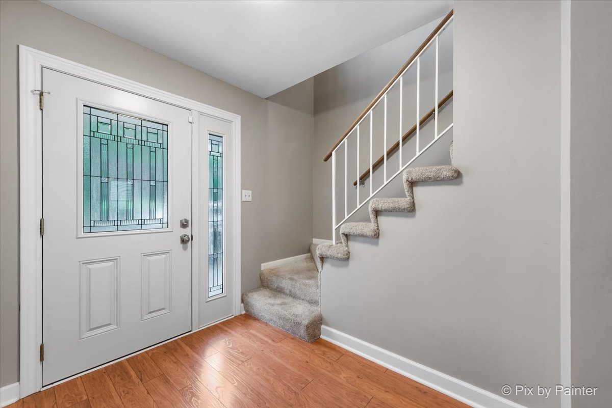 1025 Oswego Road Naperville, IL 60540 - Photo 3 of 42 a view of entryway with wooden floor