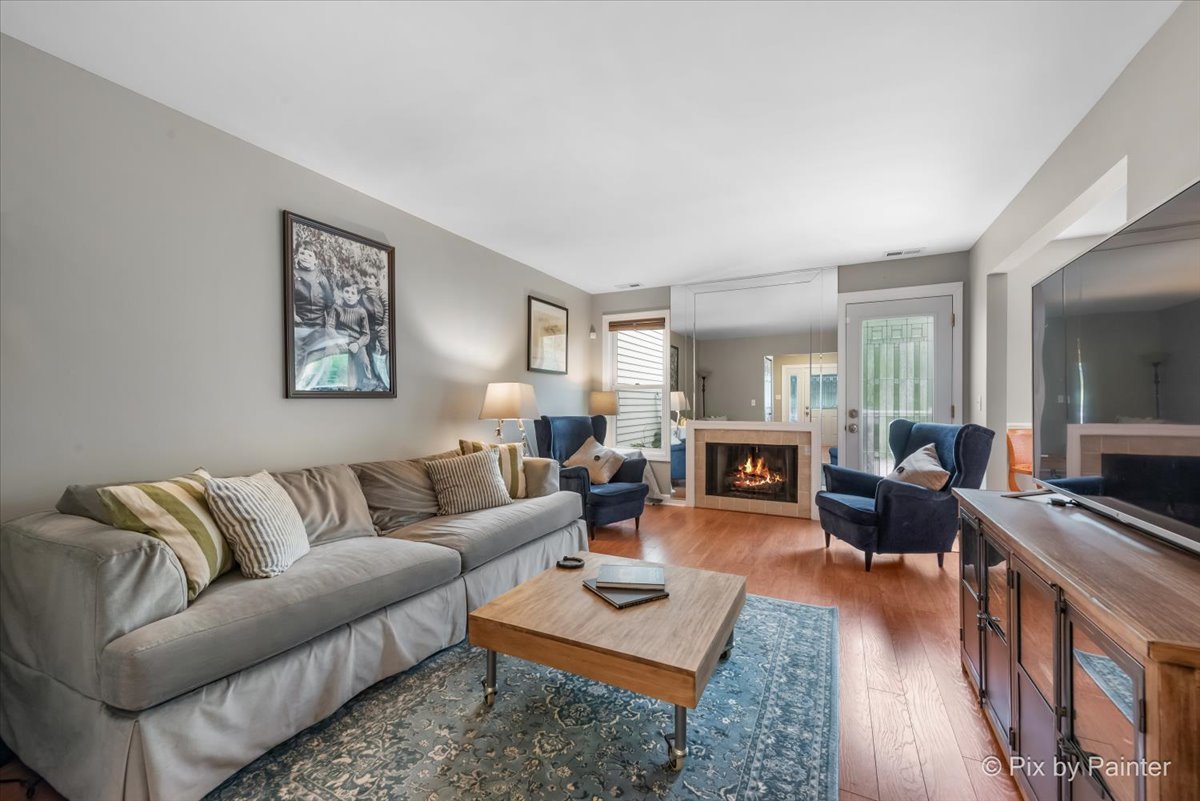 1025 Oswego Road Naperville, IL 60540 - Photo 5 of 42 a living room with furniture fireplace and wooden floor