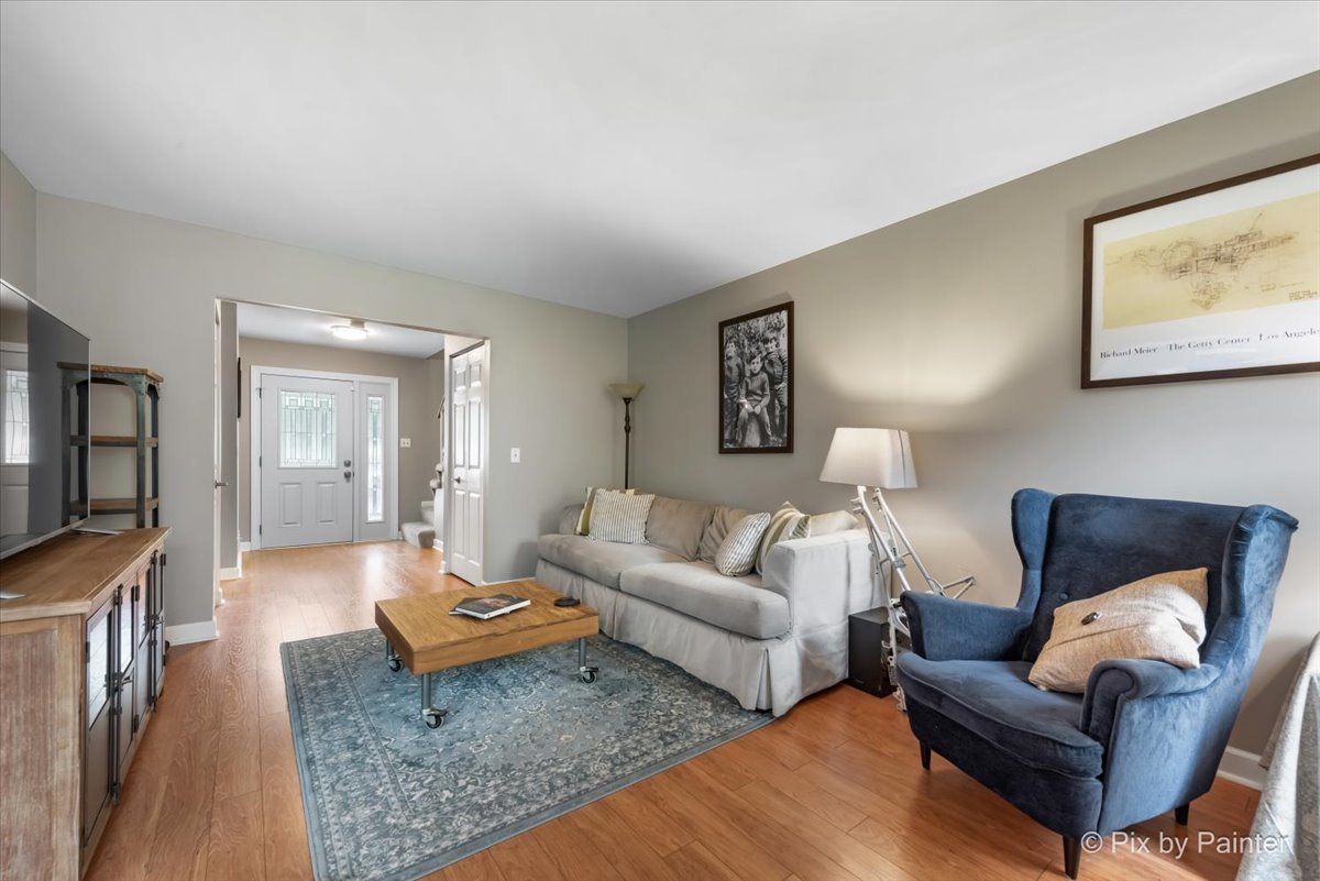 1025 Oswego Road Naperville, IL 60540 - Photo 6 of 42 a living room with furniture and a flat screen tv