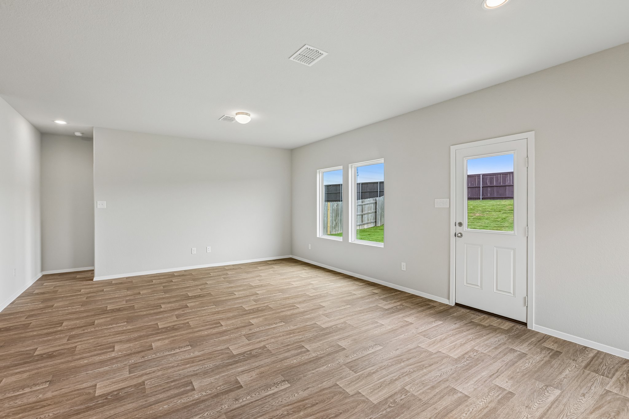 5513 Sacra Cove Austin, TX 78747 - Photo 14 of 37 a view of an empty room with wooden floor and a window