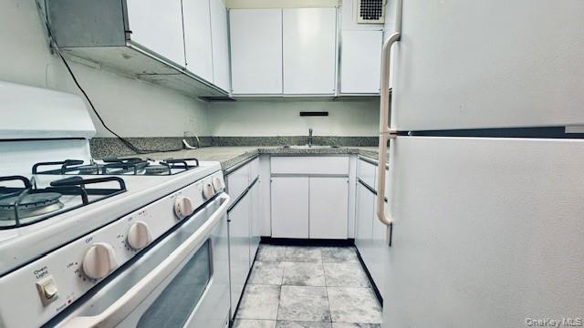 142-05 Roosevelt Avenue, Unit 521 Queens, NY 11354 - Photo 3 of 12 a kitchen with stainless steel appliances granite countertop a sink stove and cabinets
