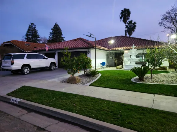 a front view of a house with a yard