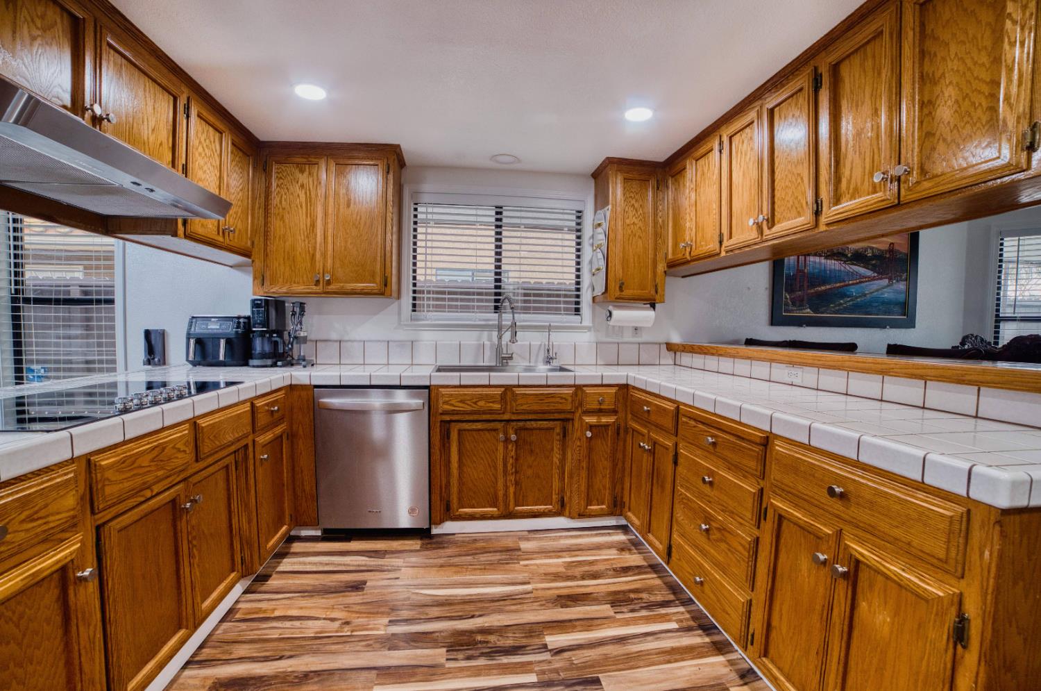 2520 Meadowrest Way Madera, CA 93637 - Photo 11 of 39 a kitchen with stainless steel appliances granite countertop wooden cabinets a sink and dishwasher