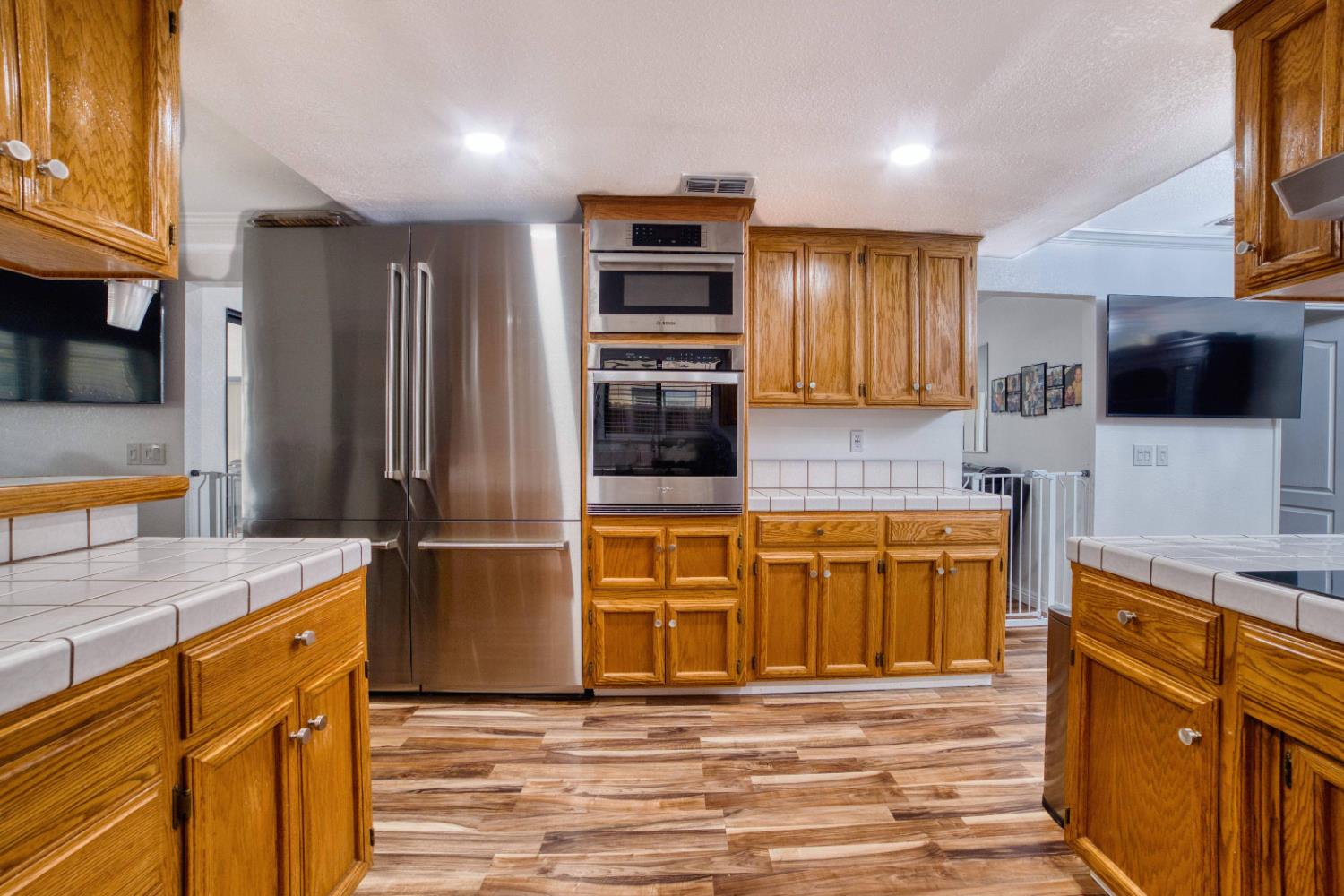 2520 Meadowrest Way Madera, CA 93637 - Photo 12 of 39 a kitchen with stainless steel appliances granite countertop a refrigerator and a stove top oven