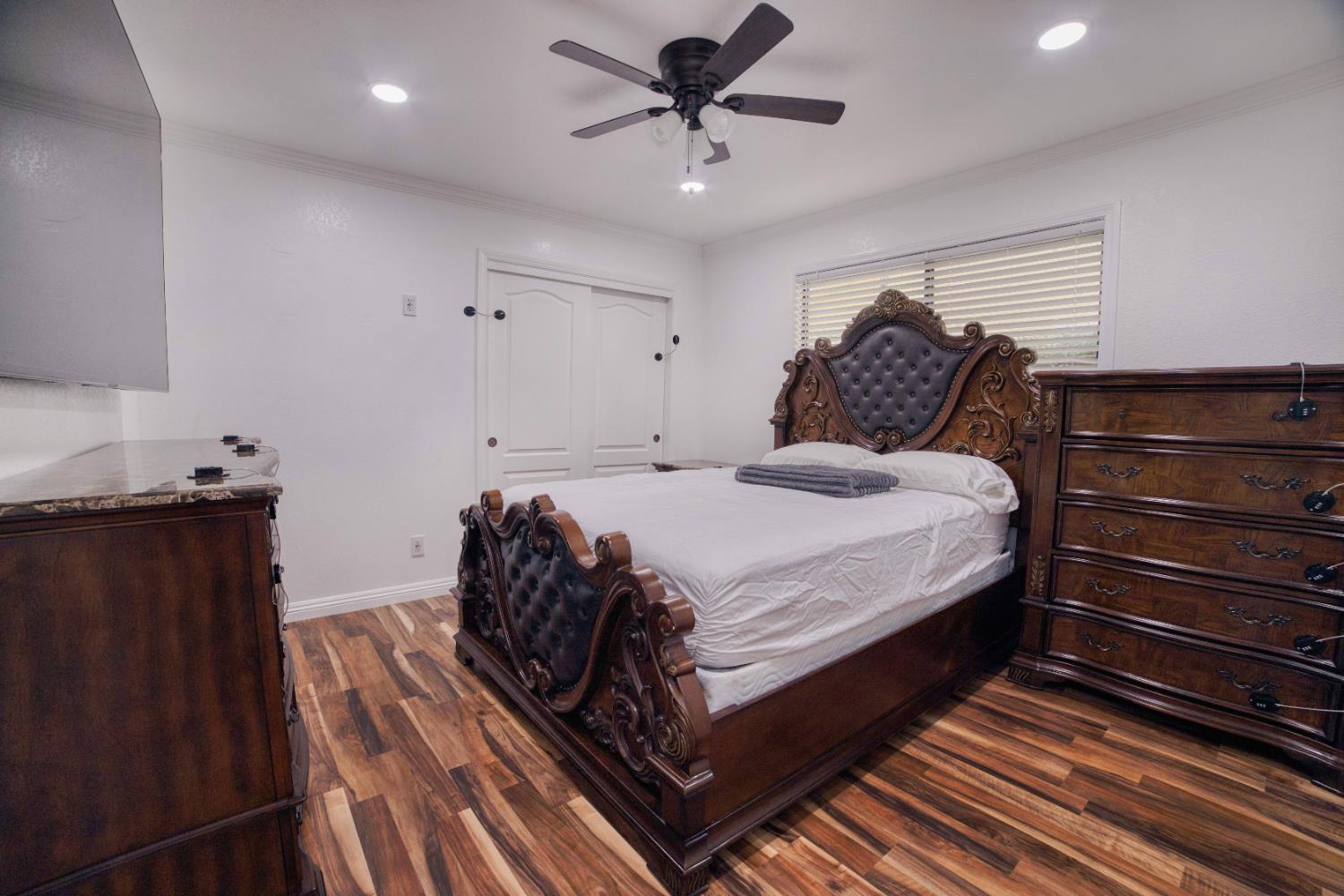 2520 Meadowrest Way Madera, CA 93637 - Photo 17 of 39 a bedroom with a bed and wooden floor