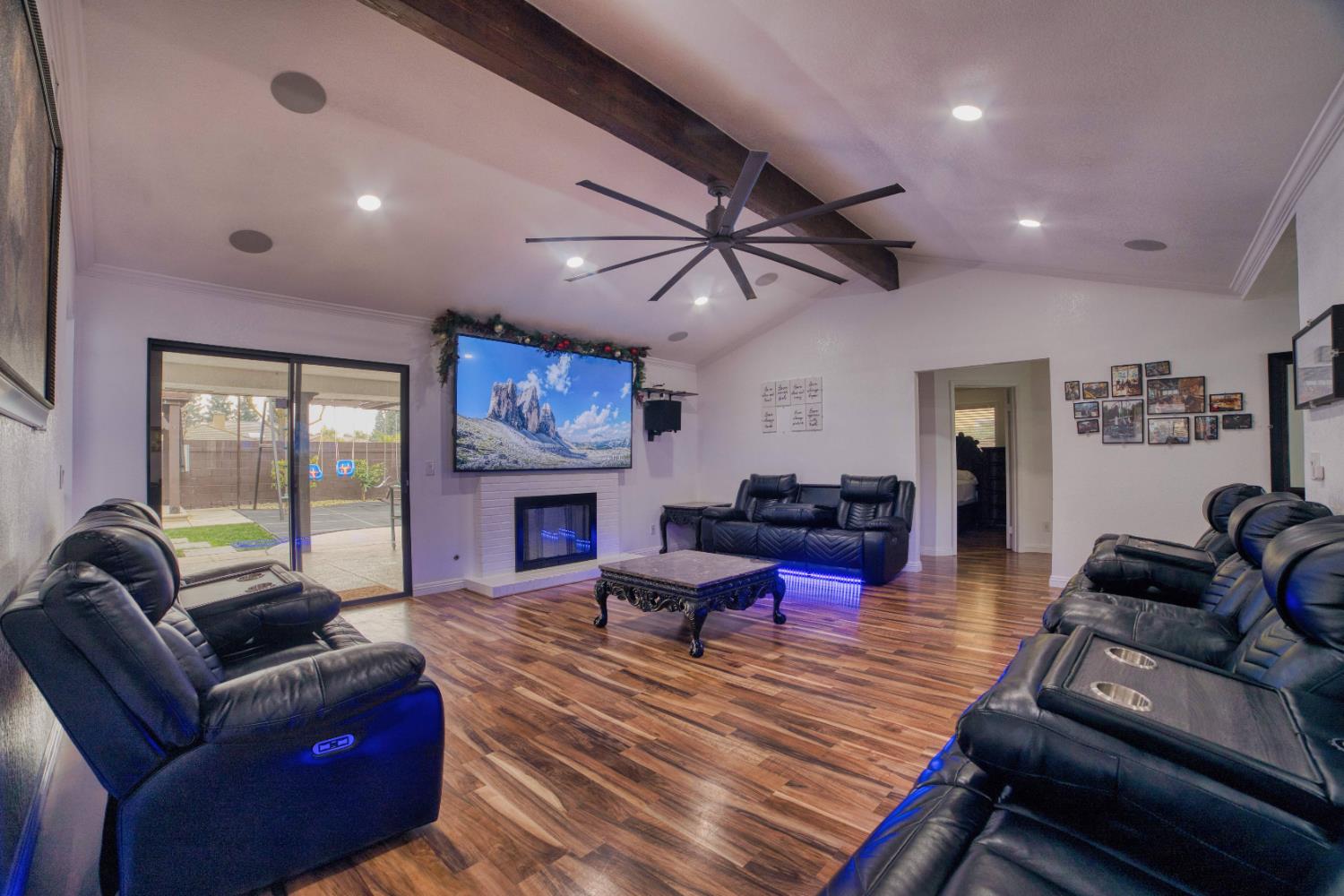 2520 Meadowrest Way Madera, CA 93637 - Photo 32 of 39 a living room with furniture a fireplace and a flat screen tv